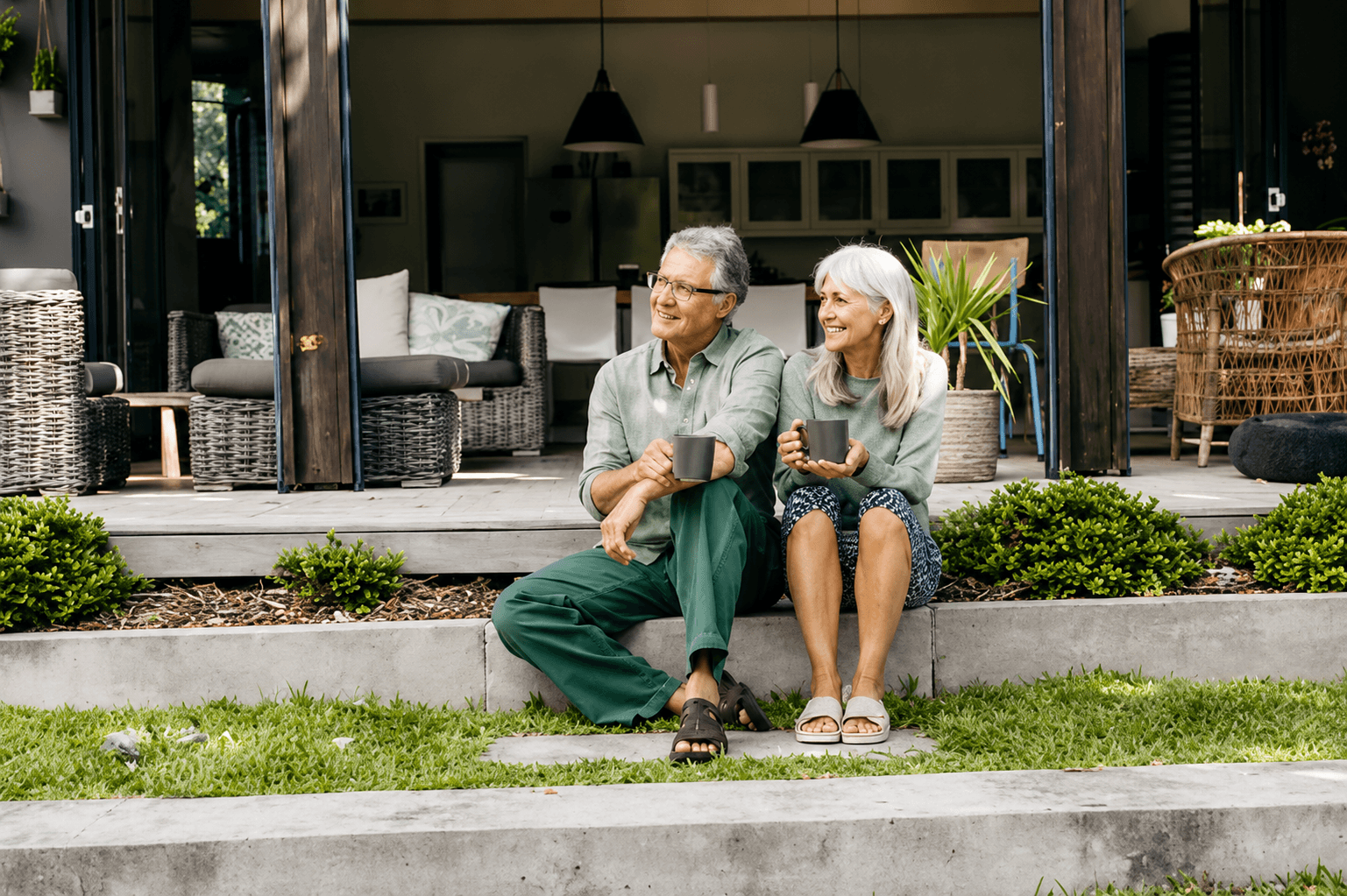 Senior couple sitting outdoors enjoying the sun